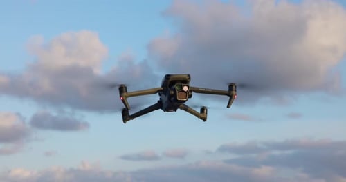 Flying DJI Mavic 3 Pro drone suspended in air