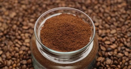 Coffee Granules in Glass Jar with Coffee Beans