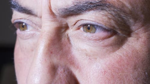 Man's Face Opens Eyes in Extreme Close Up