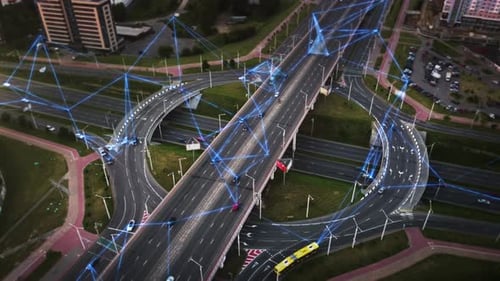 Aerial footage of a modern highway interchange with dynamic digital network visuals.
