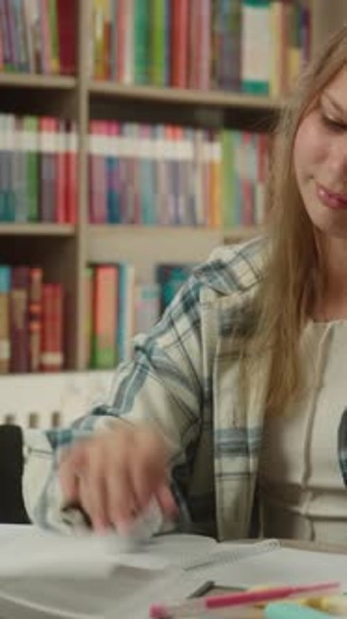 Bored Caucasian Teen School Girl Reading Book at Desk in Classroom Tired Student Looking at Camera