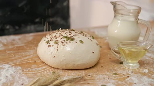 Bread Dough Ball Topped with Seeds in Kitchen