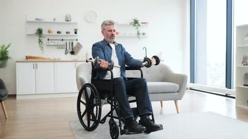 Man in Wheelchair Lifts Weights in Bright Home