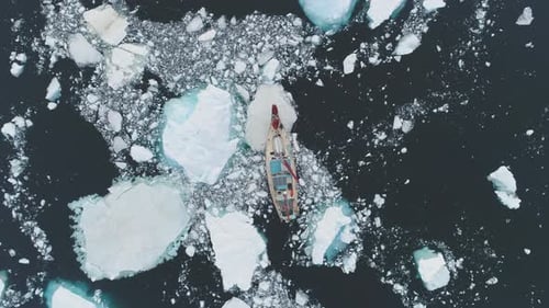 Sailing Yacht Makes Its Way Through Ice and Iceberg in Antarctica Coast