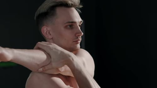 Shirtless Man Performs Shoulder Stretch Mid Shot