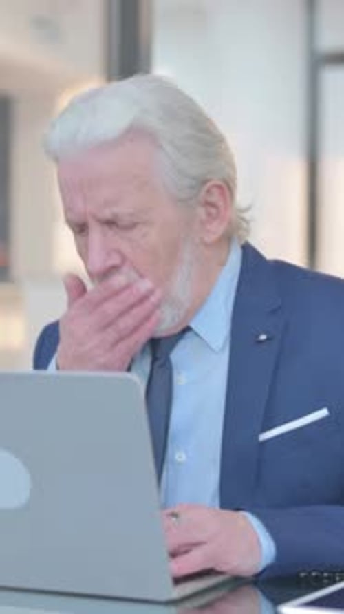 Coughing Old Businessman Using Laptop in Office, vertical video