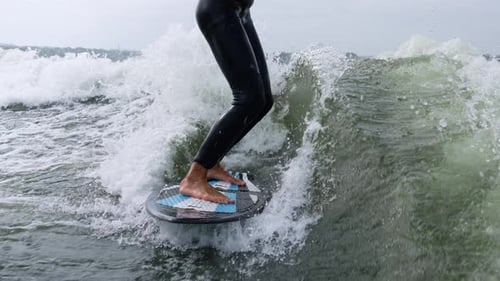 Wake Surfer in Black Wetsuit Rides the Wake
