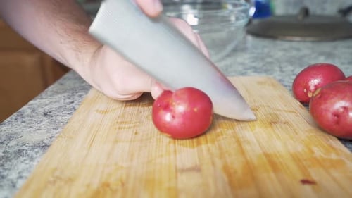 Cutting Red Potatoes on Wooden Cutting Board