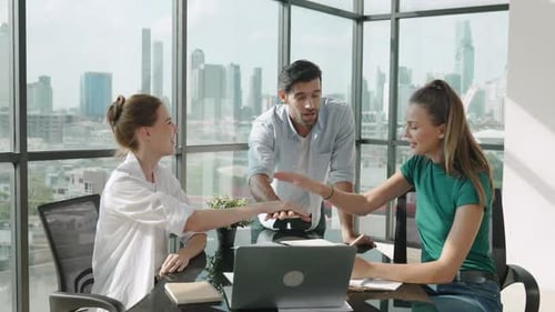 Excited Team Celebrates Success in Modern Office