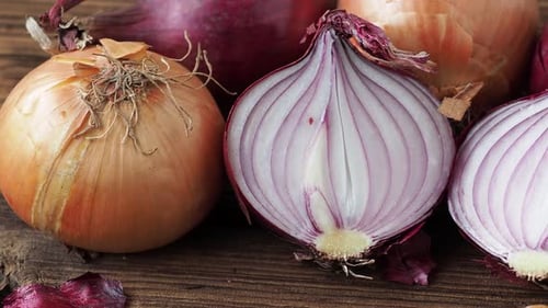 Yellow and red onions on a wooden board