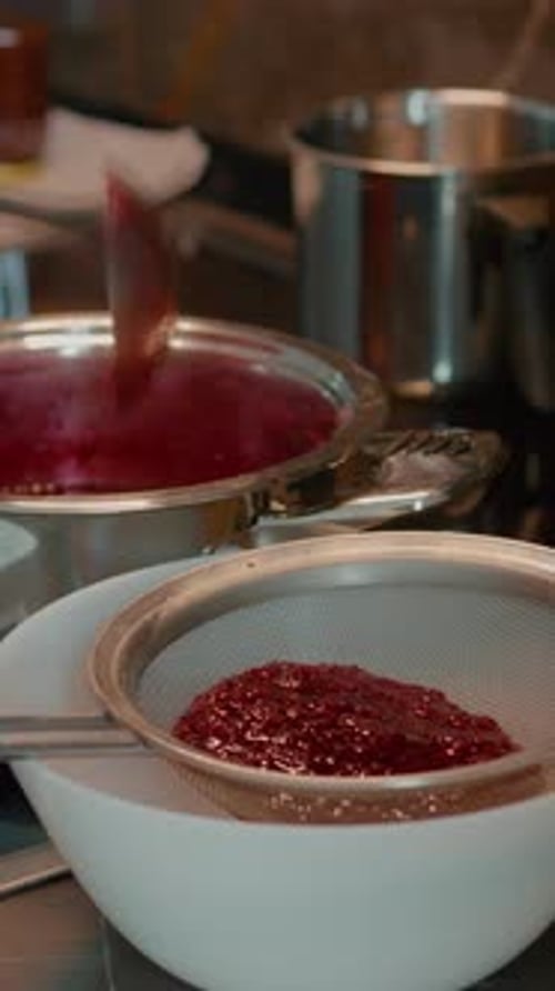 Red Sauce Being Strained in a Kitchen