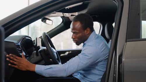 Adult Inspects Modern Car Interior Components