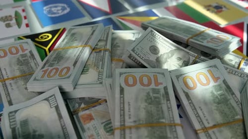 Bundles of Cash on World Flags Background