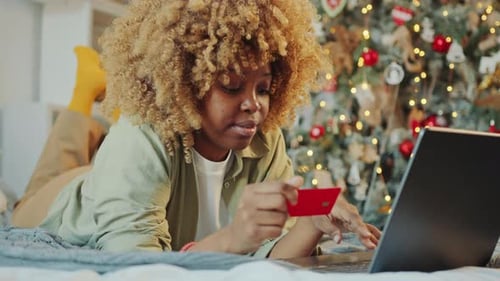 Woman Shopping Online with Laptop at Home before Christmas Day