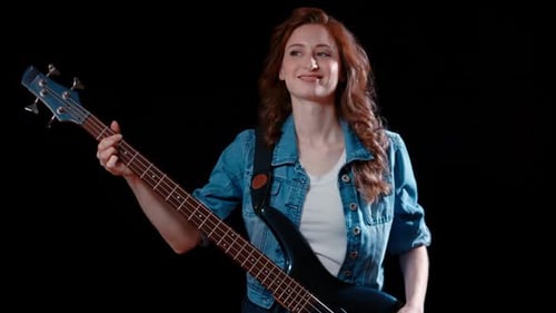 Woman Plays Bass Guitar in Studio