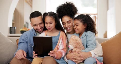 Family Looking at Tablet Together on Couch