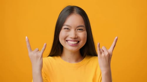 Happy Woman Posing in Front of Yellow Background
