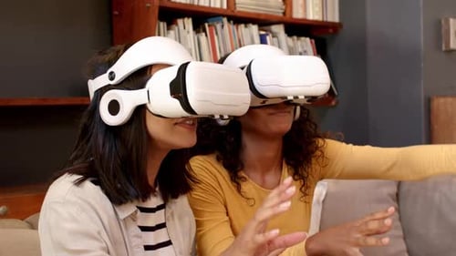 Friends Experiencing Virtual Reality Headsets on Couch