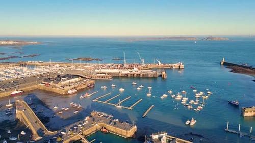 St Peter Port Harbour Guernsey.Overhead drone footage in golden hour over the harbour, ferry berth a