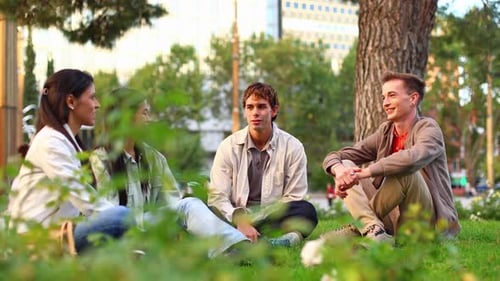 Diverse Group of Friends Chatting and Laughing in City Park