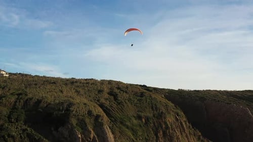 Extreme Paraglider Flying in Clear Blue Skies