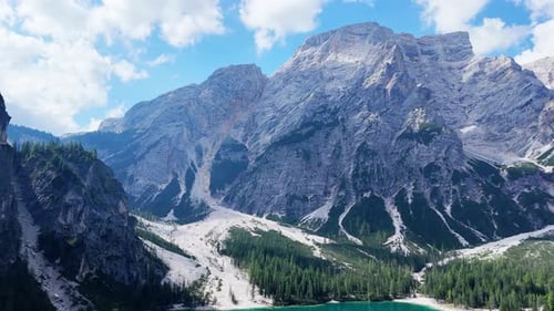 Camera panning showing beautiful mountain lake surrounded by forest