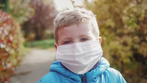 Child Wearing Protective Face Mask Outdoors