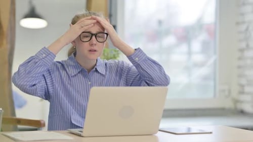 Woman Working Frustrated At Desk With Laptop