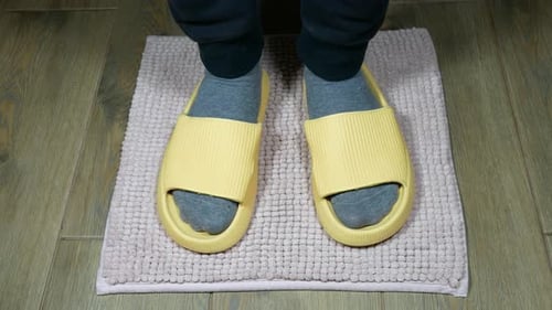 Slippers on Mat Stepped into by Foot