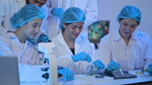 Inclusive group of medical experts wearing safety apparel shares a joyful milestone