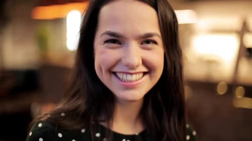 Smiling young woman close up portrait indoors