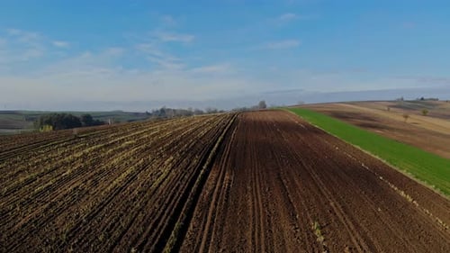 Aerial View of Plowed Field in Rural Landscape