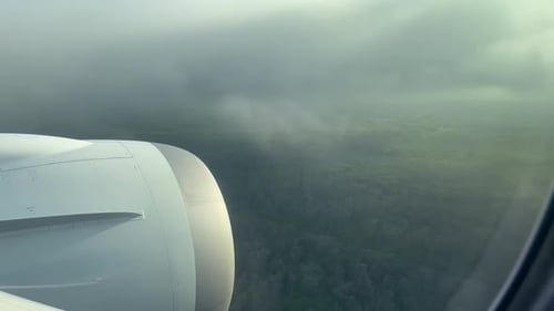 Passenger POV from airplane descending through low clouds on approach to Buenos Aires Ministro Pista