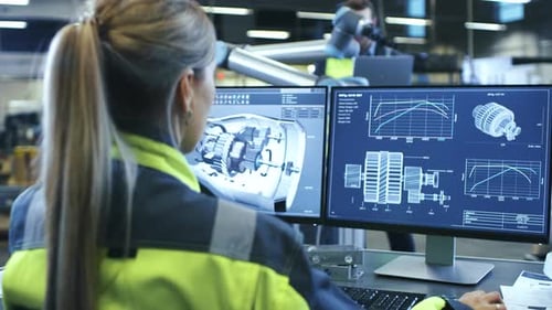 At the Factory: Female Mechanical Engineer Designs 3D Engine on Her Personal Computer while Male Au