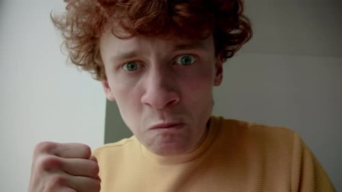 Man Making Angry Facial Expressions Close Up