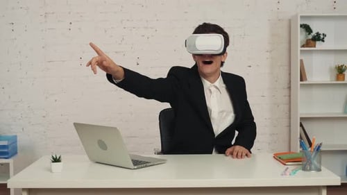 Medium Video of a Young Man in an Office Wearing Virtual Reality Vr Helmet Gear Swiping Zooming and