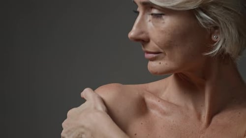 Woman Gently Touching Shoulder in Close Up Portrait