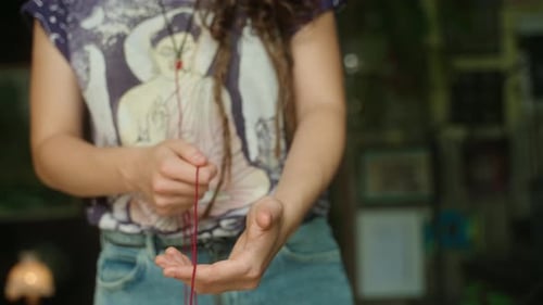 Close Up Of Slender Adult String Manipulation