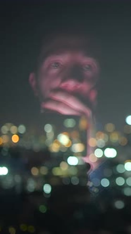Contemplative Man Amid City Glow Pensive Figure Reflected Against Shimmering City Lights at Night