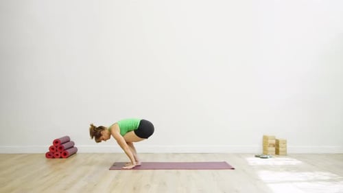 Woman in graceful bridge pose in modern studio