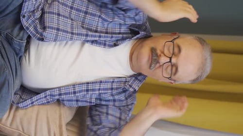 Man Rubbing Head, Face, and Chest on Couch