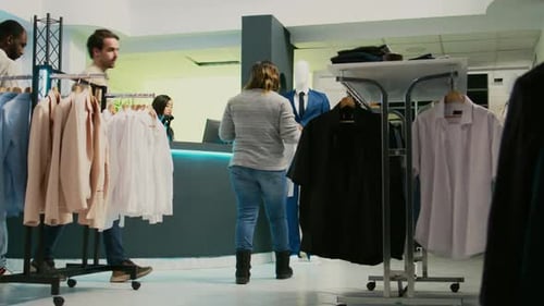 Woman Browsing Shirts in Modern Clothing Boutique