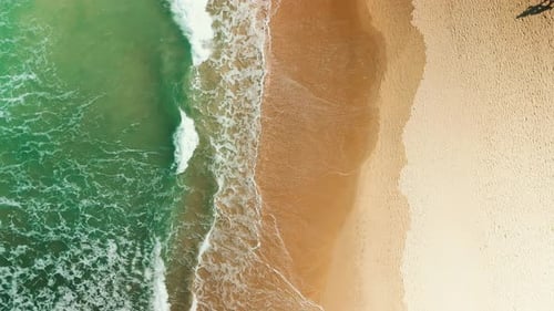 Aerial View of Waves Meeting Sandy Beach