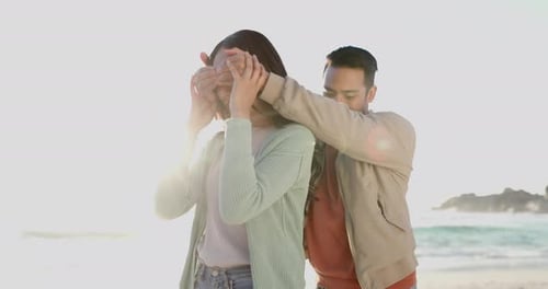 Love, surprise and happy with couple at beach for gift, summer vacation and travel