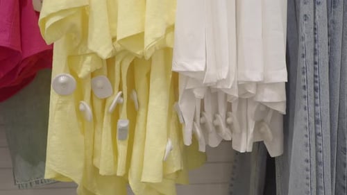 Bright Clothes with Security Tag Display in a Retail Shop