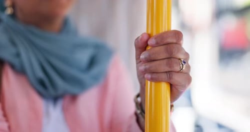 Person, hands and pole with handle on bus for public safety, transport or security on vehicle
