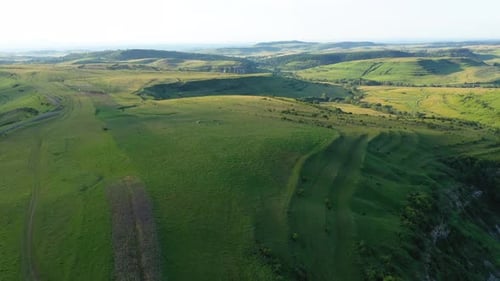 High Angle Aerial Above View of Green Meadow in the Spring, Countryside Hills