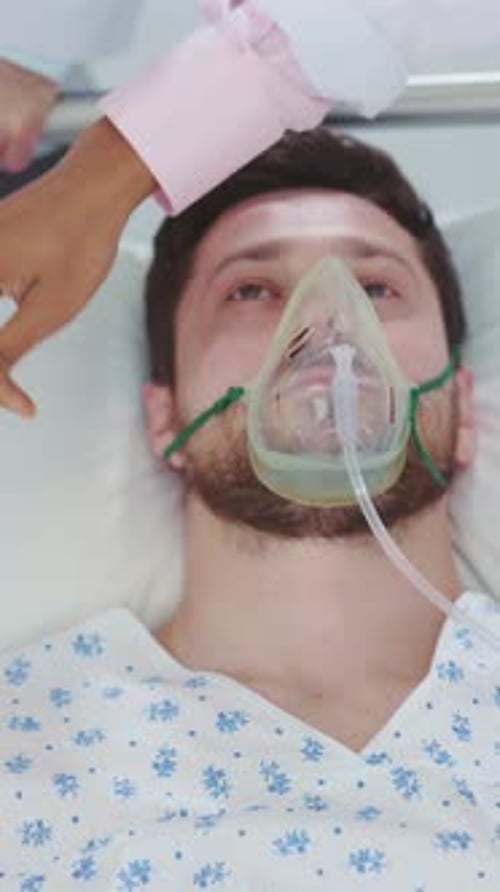 Miserable Exhausted Male Patient Lying Down on Emergency Stretcher Bed Moving Inside Hospital