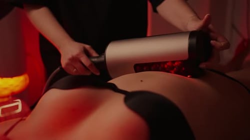 Closeup Of Roller In Masseuse Hands LED Light Therapy And RSLSculpting Methods For Beautiful Skin