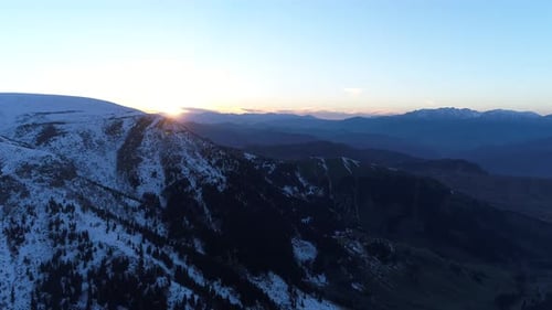Aerial Shot Of Snowy Mountains During Sunrise 6